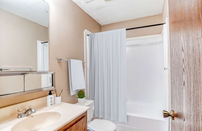 Bathroom shower tub toilet sink included bright walls - Highland Apartments