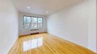 Located at 7211 Avenue Fielding in Montréal's NDG neighbourhood, this well-appointed 2-bedroom, 1-bathroom unit offers a comfortable and functional layout across a single floor. The open-concept living and kitchen area is bright and airy, with large windows allowing natural light to fill the space and offering views of the tree-lined street. Warm-toned hardwood floors run throughout, adding character and a polished finish to every room. The kitchen features light wood cabinetry, a central island with a built-in range, stainless steel appliances including a full-size refrigerator, and recessed lighting overhead. The living area is generously proportioned with a baseboard heater and clean white walls. Both bedrooms are well-sized, with the primary bedroom benefiting from a large window overlooking the neighbourhood and direct access to a private balcony. The second bedroom includes a built-in closet and recessed lighting. The bathroom is finished with striking marble-effect wall tiles surrounding a full soaker tub, complemented by a frosted window for natural light and privacy. Two hallways connect the rooms efficiently, completing this clean and move-in-ready home.