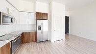 This contemporary 490 square foot apartment in Sacramento, CA, offers a well-designed living space that maximizes efficiency and style. The open-concept layout creates a seamless flow between the living areas, enhancing the sense of spaciousness. The kitchen is a standout feature, boasting a modern design with a mix of white and wood-tone cabinetry, complemented by stainless steel appliances including a side-by-side refrigerator and built-in microwave. Light wood-look flooring runs throughout the main living areas, adding warmth and continuity.

The 120 square foot bedroom features plush carpeting and a large sliding door closet, providing ample storage. The bathroom continues the modern aesthetic with a marble-look tub surround, glass shower door, and wood vanity. Large windows in both the living area and bedroom flood the space with natural light and offer views of the surrounding cityscape. The apartment's clean lines, neutral color palette, and thoughtful design elements create an inviting and functional urban living environment. Despite its compact size, this apartment efficiently accommodates all essential living spaces, making it an ideal choice for those seeking a stylish city dwelling.