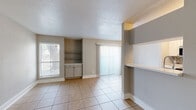 Located at 8791 Hammerly Blvd in Houston, TX, this single-story, one-bedroom, one-bathroom unit offers a practical and comfortable layout across a compact but efficiently designed floor plan. Light beige tile flooring runs throughout, lending a clean and cohesive aesthetic to every room.

The kitchen is well-equipped with white cabinetry featuring gold hardware, light stone countertops, a double stainless steel sink with a modern faucet, and full appliances including a refrigerator, range, and dishwasher. It opens toward the dining area, creating an easy flow for everyday living.

The combined dining area includes a built-in cabinet and shelving nook, adding functional storage, along with a window that lets in natural light. The living area features a sliding glass door dressed with vertical blinds, providing access to an outdoor area and a pleasant view of surrounding greenery.

The spacious bedroom offers a generous footprint with a large window that fills the room with natural light. Adjacent to the bedroom is a substantial walk-in closet outfitted with multi-level wire shelving for ample storage.

The bathroom is clean and functional, featuring a shower-tub combination, white overhead cabinetry, and light stone countertops, maintaining the bright and neutral palette found throughout the unit.