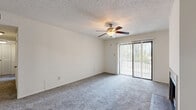 Located in Mobile, AL, this single-floor, 2-bedroom, 2-bathroom residence offers a practical and comfortable layout. The living room serves as the heart of the home, featuring plush carpeting, a ceiling fan with light fixture, a textured ceiling, and a charming brick-hearth fireplace with a brass-trimmed surround — an ideal focal point for the room. A full-width sliding glass door floods the space with natural light and opens to an outdoor area with greenery views. The kitchen is efficiently designed in a galley configuration, with warm wood cabinetry, dark granite-style countertops, wood-look flooring, and appliances including a range and dishwasher. The generously sized primary bedroom includes soft carpeting, a louvered double closet, and direct access to a full bathroom. The second bedroom also features carpet and a textured ceiling. Both bathrooms are finished consistently with wood vanity cabinets, dark granite-style countertops, large mirrors, and wood-look flooring; one includes a tub/shower combo. A hallway connects the main areas, and a dedicated closet provides additional storage. The overall palette of neutral whites and warm wood tones creates a clean, cohesive ambiance throughout.