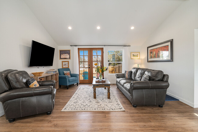 Living Room has vaulted ceilings and leather furniture - 881 3rd St