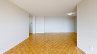This well-appointed apartment in Toronto offers 1100 square feet of thoughtfully designed living space. The unit features two bedrooms, including a spacious primary bedroom of 200 square feet, and two full bathrooms. The living area is characterized by its expansive feel, enhanced by large windows that flood the space with natural light and provide panoramic city views.

The flooring throughout is an elegant parquet, adding warmth and character to each room. The living room is generously sized, perfect for entertaining or relaxing. The modern kitchen is equipped with white cabinetry, ample counter space, and essential appliances, making it both functional and aesthetically pleasing.

Both bedrooms offer comfort and privacy, with the primary bedroom being particularly spacious. The bathrooms are clean and well-appointed, featuring contemporary fixtures and finishes. The apartment's layout includes two hallways, ensuring easy flow between rooms.

A standout feature is the balcony, offering residents an outdoor space to enjoy fresh air and city vistas. The entrance area provides a welcoming first impression. Overall, this apartment combines modern amenities with a practical layout, creating an ideal urban living space in a prime Toronto location.