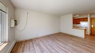 Located at 1240 Oak Terrace Dr in Traverse City, Michigan, this well-designed one-bedroom, one-bathroom unit offers a functional and comfortable layout across a single floor. Light wood-style flooring runs throughout the space, creating a consistent, clean aesthetic that ties each room together.

The combined kitchen and living area forms the heart of the unit. The galley-style kitchen is efficiently organized with warm honey-toned wood cabinetry lining both walls, providing ample upper and lower storage. A double-basin sink, white appliances including an electric range and refrigerator, and a light countertop complete this practical cooking space. The adjacent living area is bright and open, with neutral white walls and natural light filtering in through a large window that offers a pleasant view of mature outdoor greenery.

The bedroom is a comfortable, well-proportioned room featuring a full-wall closet with warm wood bi-fold doors and continued wood-style flooring. It benefits from natural light and connects easily to the rest of the unit.

The bathroom is equipped with a full tub and shower combination, accented by chrome grab bars for added accessibility and safety. Wood cabinetry provides storage, and the flooring continues the consistent design found throughout the unit. This residence offers a practical, move-in-ready layout in a serene Traverse City setting.