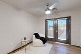 Located at 6775 N 67th Ave in Glendale, Arizona, this one-bedroom, one-bathroom unit offers a thoughtfully designed single-floor layout with a clean, modern aesthetic throughout. Light wood-look flooring flows seamlessly across all rooms, creating a cohesive and airy feel.

The kitchen is a functional centerpiece, featuring rich walnut-toned cabinetry with sleek hardware, light grey countertops, and a full suite of white appliances including a refrigerator, dishwasher, electric range, and over-the-range microwave. Recessed lighting illuminates the space efficiently.

The living area is bright and open, benefiting from natural light and a ceiling fan. A set of dark-framed French doors opens to an outdoor area, providing views and ventilation. The bedroom is a comfortable, well-proportioned room with its own ceiling fan, a large window with vertical blinds, and a curtained closet, offering a quiet and private retreat.

The bathroom is finished with a walnut-toned vanity, grey countertop, a large mirror, and a medicine cabinet, maintaining the consistent design language found throughout the unit.

Clean white walls, dark-trimmed doorways, and consistent flooring tie the entire space together, resulting in a modern, low-maintenance unit well-suited for efficient everyday living.