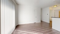 This 400 square foot apartment in Los Angeles offers a thoughtful layout maximizing space and functionality. The single-floor unit comprises one bedroom, one bathroom, and an open-concept kitchen and living area. The primary bedroom, measuring 110 square feet, provides a cozy retreat with a window allowing natural light and featuring horizontal blinds for privacy.

The kitchen boasts a modern design with white cabinetry, stainless steel appliances, and dark countertops, creating a striking contrast. A peninsula extends from the kitchen, doubling as a breakfast bar and defining the transition to the living area. The bathroom, while compact, features a clean, white aesthetic with a combination bathtub and shower.

Throughout the apartment, light-toned wood-look flooring enhances the sense of space and complements the crisp white walls. Large windows in the living area and bedroom flood the space with natural light, while vertical blinds in the living room offer flexibility in light control and privacy. The apartment's design prioritizes functionality without compromising on style, making efficient use of its 400 square feet to create a comfortable urban dwelling.