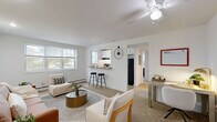 Located at 2981 Olentangy River Road in Columbus, Ohio, this two-bedroom, one-bathroom unit offers a well-organized, single-floor layout designed for comfortable everyday living. The combined kitchen and living area serves as the heart of the home, with the kitchen featuring white cabinetry, granite-style countertops, a stainless steel sink, and black appliances including an electric range and refrigerator. Light wood-style flooring and a window overlooking the surroundings bring brightness to the space. The living area is carpeted and receives natural light through a large multi-pane window, creating an inviting atmosphere. The primary bedroom is generously proportioned and includes two closets, a window, and soft carpeting. The second bedroom also offers carpeted floors, a window with natural light, a closet, and a ceiling fan. A connecting hallway links the rooms efficiently. The full bathroom is clean and bright, featuring a tub-shower combination with chrome fixtures and a small window for ventilation. Throughout the unit, white walls, neutral tones, and consistent finishes create a cohesive and functional living environment ideal for those seeking a practical residence in Columbus.
