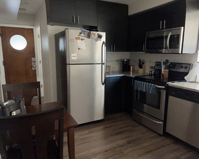 Kitchen with SS appliances and granite counter - 6626 W Devon Ave