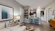 Located at 3350 Amador Dr in Fort Worth, TX, this thoughtfully designed one-bedroom, one-bathroom residence offers a smart and functional single-floor layout. The open-concept living and kitchen area forms the heart of the home, where rich dark-wood cabinetry, granite countertops, a mosaic tile backsplash, and stainless steel appliances define a well-appointed kitchen. A peninsula island with bar seating provides additional workspace and casual dining, illuminated by sleek pendant lighting. Wood-style flooring extends throughout the main living areas, complementing the neutral gray tones on the walls. Built-in shelving near the entry adds both storage and visual interest. The living area is anchored by a large window that invites natural light and connects the space to the outdoors. The bedroom is a calm, carpeted retreat with room for a full furniture arrangement, while the walk-in closet features multi-level shelving and hanging rods for organized storage. The bathroom is finished with a dark-framed mirror, granite vanity, and dark wood cabinetry consistent with the home's design language. An in-unit washer and dryer area adds everyday convenience. This residence delivers a cohesive, modern aesthetic with practical features throughout.
