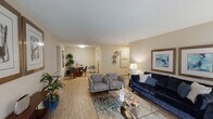 This single-floor, one-bedroom, one-bathroom residence offers a well-organized and functional layout designed to maximize comfort and livability. The open living and dining area is a welcoming centerpiece of the home, featuring wood-style flooring, neutral-toned walls, and abundant natural light filtering through multiple windows. A standout feature of the living room is the tile-surround fireplace with a wood mantel, complemented by a wall-mounted television — creating a cozy yet modern focal point. The open flow connects seamlessly to a dedicated dining area, ideal for everyday meals or entertaining.

The galley-style kitchen is efficiently designed with granite-look countertops, ample cabinetry, a subway tile backsplash, and black appliances including a range and refrigerator, offering a fully equipped cooking space.

The bedroom is a serene retreat with plush carpeting, multiple windows that invite natural light, and a ceiling fan for added comfort. The full bathroom features wood-style flooring, a granite-look vanity countertop, and a tiled shower-tub combination.

Throughout the residence, consistent finishes and a neutral color palette create a cohesive, inviting ambiance suited for comfortable everyday living.