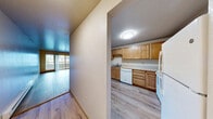 Located at 1521 N 26th St in Mount Vernon, Washington, this two-bedroom, one-bathroom unit offers a practical and comfortable single-floor layout. Light wood-style flooring runs throughout the home, creating a warm and cohesive feel from room to room.

The combined kitchen and living room area forms the heart of the unit. The living room is generously sized, featuring a sliding glass door that opens to a private balcony with outdoor views — an inviting source of natural light. A baseboard heater provides efficient warmth. The kitchen is well-appointed with warm-toned wooden cabinetry offering ample upper and lower storage, light countertops, a double sink, and white appliances including a range, refrigerator, and dishwasher.

Both bedrooms are bright and functional, each with wood-style flooring and baseboard heating. The primary bedroom is notably spacious and includes a sliding glass door to the balcony, while the second bedroom features a double sliding-door closet. A hallway connects the private areas of the unit. The full bathroom is finished with wood-toned cabinetry, a single vanity, and a tub-shower combination. The overall ambiance is clean, neutral, and move-in ready.