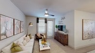 Located at 100 N Hearthstone Way in Chandler, Arizona, this single-story residence offers a thoughtfully designed layout with contemporary finishes throughout. The open-concept kitchen is a standout feature, showcasing granite countertops, white shaker cabinetry, a subway tile backsplash, stainless steel appliances, and a large island with an undermount sink and pendant lighting — ideal for both cooking and casual dining. Light wood-style flooring runs through the main living areas, lending a clean, cohesive aesthetic. The living room is bright and inviting, filled with natural light from large windows dressed with layered curtains, and is equipped with a ceiling fan. A dedicated dining area provides generous space for entertaining, also benefiting from abundant window light. The bedrooms feature plush carpeting, ceiling fans, and multiple windows that invite natural light, creating a calm and restful atmosphere. The primary bathroom offers a long vanity with granite countertops, white cabinetry, and wood-style flooring, with access to a walk-in closet. A second bathroom mirrors the refined finishes found throughout the home. The overall ambiance is modern and comfortable, with a neutral color palette and quality materials that create a polished, move-in-ready environment.