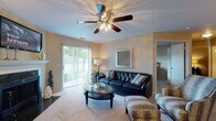 This single-story residence located on Howe Road in Strongsville, Ohio, offers a thoughtfully designed layout with a range of functional and stylish living spaces. The living room serves as the heart of the home, featuring a classic fireplace with a white mantel and black surround, plush carpeting, a ceiling fan with integrated lighting, and sliding glass doors that invite natural light and provide access to an outdoor area with views of surrounding greenery.

Adjacent to the living room, a dedicated dining area accommodates a full-sized table beneath a pendant light fixture, creating a defined space for meals and entertaining. The galley-style kitchen is well-equipped with dark cabinetry, granite-style countertops, stainless steel appliances including a range, microwave, refrigerator, and dishwasher, and durable tile flooring.

The bedrooms offer carpeted floors, generous natural light through vertical-blind windows, and warm, neutral tones. The primary bedroom connects to a hallway leading to dual vanity areas with dark cabinetry and granite countertops. A secondary bathroom features matching dark cabinetry, granite countertops, wood-look tile flooring, and a tub-shower combination, delivering a cohesive and polished finish throughout.
