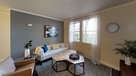 Located at 4101 Innovator Dr in Sacramento, California, this single-floor residence offers a thoughtfully designed layout that balances style and functionality. The living room is a welcoming space featuring crown molding, soft neutral and slate-gray toned walls, and large windows dressed with sheer white curtains that invite generous natural light and views of the surrounding greenery. A tufted white sofa, geometric coffee tables, and curated wall art contribute to the room's modern, polished aesthetic.

Adjacent to the living area, the dining space accommodates a full dining table and bench seating beneath a sleek ceiling fan, while a wall-mounted flat-screen TV and rustic wood media console complete the open living-dining zone. The kitchen is equipped with rich dark cabinetry, light granite countertops, stainless steel appliances including a range and built-in microwave, a deep undermount sink, and hardwood-style flooring — offering both visual contrast and practical workspace.

The bedroom features a bold accent wall, crown molding, ceiling fan, plush carpeting, and ample closet access, creating a restful retreat. The bathroom is finished with dark vanity cabinetry, granite countertops, hardwood-style flooring, and a full tub-shower combination, providing a clean and functional space.