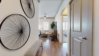 Located at 4121 San Antonio St in Odessa, TX, this single-story 2-bedroom, 2-bathroom residence offers a thoughtfully designed layout across a comfortable footprint. Wood-style flooring flows throughout the main living areas, complemented by crown molding and ceiling fans that add a polished finish to each room.

The entryway opens into a hallway with decorative wall art and an arched architectural detail that leads into the living room. The living area features a ceiling fan, multiple windows for natural light, and direct access to an outdoor patio through a glass door. The kitchen is a standout space, boasting dark espresso cabinetry, granite countertops, a center island with a sink and pendant lighting, and stainless steel appliances. The adjacent dining area is bathed in natural light from a wraparound window arrangement with sheer drapery.

Both bedrooms are carpeted and well-sized, each with windows that allow ample natural light. The primary bedroom includes its own closet and access to a private bathroom featuring a granite-topped vanity with dark cabinetry, a glass-enclosed shower, and wood-style flooring. A second full bathroom serves the additional bedroom. Two hallways and two closets further enhance storage and circulation throughout the home.