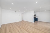 Located on Van Nuys Boulevard in Los Angeles, this 2-bedroom, 1-bathroom unit delivers a clean, modern aesthetic throughout its thoughtfully arranged single-floor layout. Light wood vinyl flooring flows seamlessly through every room, brightening the space and creating a cohesive, contemporary feel.

The open living area is bathed in recessed lighting and features crisp white walls, offering a versatile and welcoming space. It connects naturally to the galley-style kitchen, which is a true standout — bold navy lower cabinetry is paired with white upper cabinets, white quartz countertops, a subway tile backsplash, and a full suite of stainless steel appliances including a gas range, microwave, refrigerator, and dishwasher.

Both bedrooms are well-proportioned and finished with the same light wood flooring. Each room features a ceiling fan, natural light from windows with blinds, and clean white walls. The primary bedroom includes a mirrored sliding closet, adding depth and practicality. A dedicated closet provides additional storage.

The bathroom continues the navy and white design theme, featuring a full soaking tub with shower, coordinating navy vanity cabinetry, and bright white finishes throughout. A connecting hallway ties all rooms together efficiently, completing this stylish and functional home.
