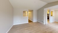Located at 32200 Military Rd S in Federal Way, WA, this 2-bedroom, 2-bathroom unit offers a well-designed single-floor layout. The open-concept living, dining, and kitchen area serves as the heart of the home, featuring light wood-look flooring and a striking tiled fireplace with a built-in arched niche — a clear focal point of the living room. Natural light flows in through multiple windows, enhancing the bright, neutral color palette throughout. The kitchen is equipped with stainless steel appliances, including a full-size refrigerator, range, microwave, and dishwasher, complemented by warm wood cabinetry, light countertops, and a pass-through window to the living area. A separate pantry adds convenient storage. The primary bedroom features plush carpeting and direct access to an en-suite bathroom with a walk-in glass shower. The second bedroom, also carpeted, includes a window with natural light and easy access to the second full bathroom, which offers a tub-shower combo and wood-toned vanity. Additional highlights include three closets, a dedicated laundry area, a private patio, and slate tile flooring at the entryway. The space delivers a functional, comfortable layout suited for everyday living.