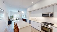 Located at 4624 North 73rd Street in Scottsdale, Arizona, this thoughtfully designed one-bedroom, one-bathroom residence offers a contemporary open-concept layout with clean lines and a bright, modern aesthetic throughout. Light wood-tone flooring flows seamlessly across the entire space, complemented by crisp white walls and abundant natural light from large windows.

The kitchen is a standout feature, boasting flat-front white cabinetry extending to the ceiling, a white quartz countertop island with seating, and a full suite of stainless steel appliances including a gas range, dishwasher, microwave, and refrigerator. Globe pendant lights above the island add a stylish finishing touch. The kitchen opens directly into the living room, which features a ceiling fan, large windows, and access to an outdoor area, creating a seamless indoor-outdoor connection.

The bedroom is well-proportioned, bathed in natural light through multiple windows with outdoor views, and includes a ceiling fan. The bathroom is elegantly appointed with a glass-enclosed walk-in shower featuring decorative patterned tile, a floating vanity with a quartz countertop, and light tile flooring. A dedicated closet and hallway complete the efficient, well-organized floor plan of this polished Scottsdale residence.