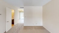 Located at 1840 W 76th St in Richfield, Minnesota, this two-floor home offers a thoughtfully designed layout with a blend of hardwood flooring and plush carpeting throughout. The main level features an open living area highlighted by warm hardwood floors, neutral walls, and ample natural light streaming through large windows fitted with blinds. A dedicated entry area with tile flooring provides a welcoming transition into the home. The kitchen is a functional standout, equipped with rich wood cabinetry, granite countertops, stainless steel appliances including a refrigerator and range, a built-in cooktop with a prominent overhead range hood, and tile flooring — making it both practical and visually appealing. Adjacent carpeted rooms offer flexible living or dining space, each bathed in natural light. The bathrooms are clean and well-maintained: one features a pedestal-style sink with a wall mirror, while another includes a wood-toned vanity, tub-shower combo with sliding glass doors, and hardwood flooring. A staircase connects the two levels, as seen in the dollhouse view, which also reveals the efficient and well-organized floor plan. The home's consistent neutral palette and mix of flooring materials create a warm, inviting ambiance throughout.