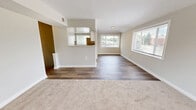 Located at 17112 Waverly Way in Baltimore, MD, this 2-bedroom, 1-bathroom home offers a well-organized single-floor layout designed for comfortable everyday living. The combined kitchen and living room serves as the heart of the home, featuring wood-look flooring, recessed lighting, and a clean, open flow between spaces. The kitchen is equipped with white cabinetry, a stainless steel refrigerator, range, dishwasher, and a window that brings in natural light. A peninsula counter provides additional workspace and visual separation from the living area. The living room extends the space further, with a large window overlooking the neighborhood streetscape, allowing ample daylight to fill the room. Both bedrooms are carpeted and finished in neutral tones, each featuring windows with outdoor views of surrounding greenery. The primary bedroom offers a comfortable, well-proportioned layout. The full bathroom includes a tub-shower combination, vanity with storage, wood-look flooring, and a frosted window for privacy and light. A hallway connects the main rooms efficiently, completing the functional and cohesive layout of this Baltimore home.