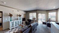 This well-appointed one-bedroom, one-bathroom residence with a study is located in Spring, TX, and offers a comfortable, modern living experience across a single floor. The open-concept living area is bright and welcoming, featuring plush carpeting, crown molding, and large windows paired with sliding glass doors that invite natural light and provide access to a private patio. The versatile study area flows naturally from the living space, offering a dedicated zone for work or relaxation.

The kitchen is a functional highlight, showcasing rich dark cabinetry, gleaming granite countertops, a tile mosaic backsplash, and stainless steel appliances including a refrigerator, electric range, and built-in microwave. A peninsula with an undermount sink and bar seating connects the kitchen seamlessly to the living and dining areas.

The spacious bedroom is fitted with soft carpet, a ceiling fan, ample natural light, and a walk-in closet. The bathroom complements the overall aesthetic with granite countertops, dark cabinetry, a framed mirror, and wood-look flooring. Neutral tones, dark wood accents, and consistent modern finishes throughout create a cohesive and refined ambiance.