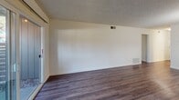 This 750 square foot apartment in Davis, California offers a well-designed living space with three bedrooms and two bathrooms. The single-story layout maximizes functionality within its compact footprint. The primary bedroom, measuring 150 square feet, provides a spacious retreat.

Throughout the apartment, modern finishes create a fresh and inviting atmosphere. Wood-look flooring in the main living areas adds warmth and durability. The kitchen features white cabinetry, granite countertops, and essential appliances, including a stove and microwave.

Large sliding glass doors in the living area allow natural light to flood the space and provide access to an outdoor area, extending the living space. Bedrooms are carpeted for comfort and include built-in closets for storage. The bathrooms are fitted with neutral-toned surfaces and standard fixtures.

The apartment's layout includes a combined kitchen and living room, creating an open feel in the main living space. This design promotes a sense of spaciousness within the compact floor plan. Located in the Portage Bay West complex, this apartment offers a balance of comfort and convenience in a desirable Davis location.