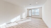 Located at 451 W Blount Ave in Knoxville, Tennessee, this thoughtfully designed 3-bedroom, 2-bathroom single-floor residence offers a clean, contemporary aesthetic throughout. The open-concept kitchen and living area serves as the heart of the home, featuring light hardwood-style flooring, recessed lighting, and large windows that flood the space with natural light. The kitchen is well-appointed with crisp white shaker cabinetry, bold dark countertops, a subway tile backsplash, a center island with an undermount sink, and a full suite of stainless steel appliances including a refrigerator, range, microwave, and dishwasher. Pendant lighting above the island adds a stylish finishing touch. The three bedrooms are carpeted for comfort, each offering ceiling fans and generous natural light from well-placed windows. The spacious primary bedroom provides a notably generous footprint. Both bathrooms are finished with white cabinetry, dark countertops, and light hardwood-style flooring; the primary bath features a dual-sink vanity with a large mirror and a tiled walk-in shower. Additional highlights include five closets, a dedicated laundry room, a utility room, and two balconies for outdoor enjoyment. The overall palette of whites and neutrals creates a bright, modern atmosphere throughout.