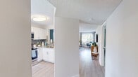 Located at 5100 West Sample Road in Coconut Creek, Florida, this one-bedroom, one-bathroom residence offers a thoughtfully designed layout that maximizes comfort and functionality. Light wood-style flooring flows throughout, complementing the bright, neutral palette found across the space.

The open-concept kitchen and living area form the heart of the home. The kitchen is outfitted with white shaker cabinetry, granite countertops, a tile backsplash, and stainless steel appliances, including a refrigerator, range, and microwave. A stacked in-unit washer and dryer is conveniently integrated into the kitchen area. The living room receives generous natural light through large windows and a sliding glass door that opens to a private balcony, creating a seamless indoor-outdoor connection.

The spacious primary bedroom features a bold teal accent wall, its own sliding glass door to the balcony, and a dedicated closet. The bathroom includes a tub-shower combination with tile surround, a granite-topped vanity, and a mirror.

A textured ceiling is consistent throughout the residence. The overall ambiance is bright and airy, reflecting a clean, contemporary coastal aesthetic well-suited to the South Florida setting.