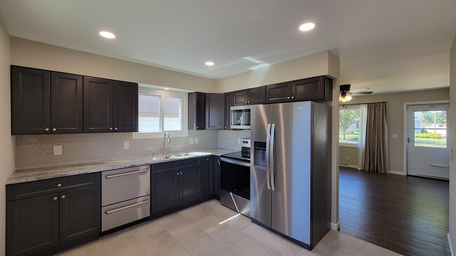 New Kitchen Cabinets and quartzite countertops. New stainless appliances. New Tile and backsplash. - 6305 49th Ave