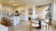 Located at 9850 Zenith Meridian Drive in Englewood, CO, this 910-square-foot, single-story apartment offers 2 bedrooms and 2 bathrooms thoughtfully arranged across a well-designed floor plan. The open-concept kitchen and living area serves as the heart of the home, featuring white shaker cabinetry, granite countertops, a center island with bar seating, stainless steel appliances including a French door refrigerator and range, and light wood-look flooring that flows throughout. The living room provides generous natural light through large windows and offers a comfortable, airy atmosphere. Both bedrooms are well-proportioned, with the primary bedroom spanning 130 square feet, and each room is fitted with ceiling fans, large windows admitting ample daylight, and light wood-look flooring. The two bathrooms are finished consistently with granite-top vanities, white shaker cabinets, black matte hardware, tile-surround tub-shower combinations, and wood-look flooring. A dedicated closet and hallway complete the layout. Clean white walls, recessed lighting, and cohesive modern finishes give the entire unit a bright, contemporary feel throughout.