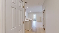 Located at 98 Waterside Drive in Wildwood, MO, this two-story home offers three bedrooms, two bathrooms, and a well-organized layout across its two levels. The main living level hosts an open-concept kitchen and living room, where light hardwood-style flooring flows throughout. The kitchen is outfitted with white shaker cabinetry, bright white countertops, and a full suite of stainless steel appliances including a gas range, over-the-range microwave, and refrigerator. The adjacent living room is highlighted by a classic fireplace with a white marble surround and mantel, a ceiling fan, and a sliding glass door that invites natural light and provides outdoor access. The bedrooms feature plush carpeting and neutral wall tones, offering a calm and comfortable retreat. The primary bedroom includes access to a dedicated walk-in closet lined with wire shelving on both sides. The bathrooms are finished with light tile flooring, white cabinetry with granite-style countertops, and a tub/shower combination. A dedicated laundry room includes a washer, wire shelving for storage, and a water heater. The attached garage completes the home, providing secure parking and additional storage space.