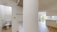 Located in the desirable Westwood neighborhood of Los Angeles, this one-bedroom, one-bathroom unit offers a thoughtfully arranged single-floor layout. The living room serves as the heart of the space, anchored by a striking white-painted fireplace with a bold vertical surround. Light wood-look flooring flows throughout the main living areas, complemented by neutral white walls and a textured ceiling. A subtle step detail near the fireplace adds architectural interest and visual depth to the room. Sliding glass doors lead to a balcony, inviting natural light and outdoor views into the living space, with a pendant light fixture adding a classic touch overhead. The kitchen is efficiently designed with white cabinetry extending to the ceiling, warm wood-tone countertops, tile flooring, and a full suite of appliances including a gas range, refrigerator, and dishwasher. A pass-through window connects the kitchen to the living area. The bedroom is a comfortable, well-proportioned retreat with light wood floors and a large sliding window that brings in natural light. The bathroom features a wide vanity with dual mirrors, white cabinetry, and tile flooring. A dedicated closet provides additional storage, completing this well-organized and inviting space.