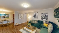 Located at 2700 Whitney Ave in Harvey, Louisiana, this 1-bedroom, 1-bathroom unit offers a thoughtfully designed single-floor layout that maximizes every square foot. The living room serves as the heart of the space, showcasing wood-look flooring, crown molding, and flush ceiling lighting. A sliding glass door with vertical blinds invites natural light and connects the interior to the outside. The kitchen features rich dark wood cabinetry, granite-style countertops, a mosaic tile backsplash, and stainless steel appliances, including a refrigerator and range, offering a functional and attractive cooking space. The bedroom is a serene retreat with plush carpet flooring, a large window dressed with sheer curtains and blinds, and ample room for a full furniture arrangement. A closet provides dedicated storage within the bedroom. The bathroom includes a wood-vanity with a white countertop and a full shower-tub combination. A hallway connects the rooms cohesively throughout the unit. Crown molding details in the living area add an elegant finishing touch, while the overall neutral color palette creates a warm and inviting ambiance throughout the home.