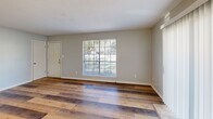 Located at 300 N Military Rd in Slidell, Louisiana, this single-floor, 2-bedroom, 1-bathroom home offers a practical and comfortable layout designed for easy everyday living. The living room greets you with warm wood-look plank flooring, neutral gray walls, and a large sliding glass door fitted with vertical blinds that allows natural light to flow in and provides outdoor access. A front-facing window further brightens the space, creating an open and airy feel. The dining area transitions seamlessly from the living room and features light tile flooring, a stylish pendant chandelier, and a window with horizontal blinds. Adjacent to the dining space, the kitchen is efficiently arranged with gray cabinetry, a double-basin sink, and includes major appliances. A stacked washer and dryer unit is conveniently tucked into the kitchen area. Both bedrooms are carpeted and include ceiling fans with light fixtures. The primary bedroom offers a closet and a window with outdoor views, while the second bedroom provides additional closet access via dual interior doors. The bathroom is well-appointed with a single-sink vanity, wood-toned cabinetry, a full tub-shower combination, and light tile flooring. Throughout the home, neutral tones and consistent finishes create a cohesive and move-in-ready atmosphere.