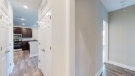 Located at 510 Ridgewood Ln in Winchester, Virginia, this well-appointed single-floor home offers four bedrooms, two full bathrooms, and a thoughtfully designed layout that balances comfort and functionality. The entrance leads into a hallway that connects the living spaces seamlessly.

The combined kitchen and living room serves as the heart of the home. The kitchen is outfitted with rich dark-wood cabinetry, granite countertops, and stainless steel appliances including a range and over-the-range microwave, all set above durable hardwood-style flooring.

The primary bedroom is a generously sized retreat featuring a distinctive bay window with a charming oval accent window above it, flooding the room with natural light and offering views of the surrounding neighborhood. Plush carpeting extends throughout all four bedrooms, with ceiling fans providing added comfort in several rooms.

Both bathrooms are finished with matching dark cabinetry, granite countertops, and tile flooring. One bathroom includes a walk-in shower, while the other offers a full tub-shower combo. Neutral gray and beige tones carry throughout the home, creating a cohesive, move-in-ready aesthetic. Clean white trim and panel doors complete the polished interior look.