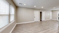 This recently renovated apartment, located at 114-119 E Cuthbert Blvd in Haddon Township, NJ, offers 640 square feet of modern living space. The single-story layout includes two bedrooms, one bathroom, a kitchen, living room, and hallway. The primary bedroom is generously sized at 150 square feet, providing ample space for comfort.

Throughout the apartment, light gray walls and white trim create a bright, airy atmosphere, complemented by sleek wood-look vinyl flooring. Recessed lighting fixtures are strategically placed to enhance illumination. Large windows in the bedrooms and living areas allow for abundant natural light, contributing to the open feel of the space.

The kitchen boasts a contemporary design with crisp white cabinetry, stainless steel appliances, and a functional L-shaped layout. It features a gas range, built-in microwave, and a full-sized refrigerator, making it well-equipped for daily cooking needs.

The bathroom presents a clean, modern aesthetic with a white vanity, mirror, and updated fixtures. The hallway provides access to all rooms and includes closet space for additional storage.

Overall, this apartment offers a fresh, updated living space with a neutral color palette, allowing for easy personalization while providing all the essentials for comfortable urban living.