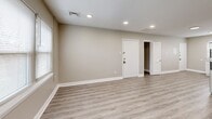 This recently renovated apartment, located at 114-119 E Cuthbert Blvd in Haddon Township, NJ, offers 640 square feet of modern living space. The single-story layout includes two bedrooms, one bathroom, a kitchen, living room, and hallway. The primary bedroom is generously sized at 150 square feet, providing ample space for comfort.

Throughout the apartment, light gray walls and white trim create a bright, airy atmosphere, complemented by sleek wood-look vinyl flooring. Recessed lighting fixtures are strategically placed to enhance illumination. Large windows in the bedrooms and living areas allow for abundant natural light, contributing to the open feel of the space.

The kitchen boasts a contemporary design with crisp white cabinetry, stainless steel appliances, and a functional L-shaped layout. It features a gas range, built-in microwave, and a full-sized refrigerator, making it well-equipped for daily cooking needs.

The bathroom presents a clean, modern aesthetic with a white vanity, mirror, and updated fixtures. The hallway provides access to all rooms and includes closet space for additional storage.

Overall, this apartment offers a fresh, updated living space with a neutral color palette, allowing for easy personalization while providing all the essentials for comfortable urban living.