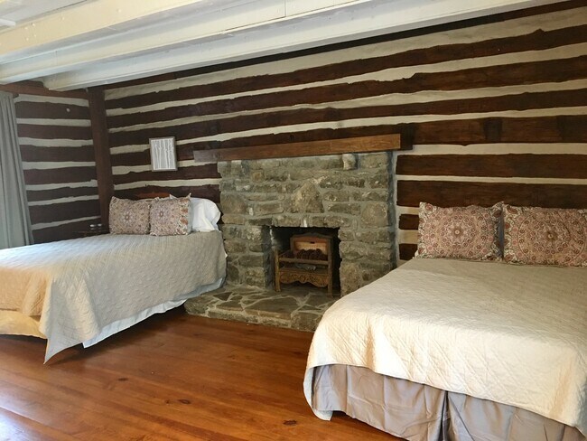 Beautiful stone fireplace and gleaming hardwood floors make this home so cozy and welcoming! - 4949 Buena Vista Pike