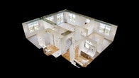This 950-square-foot, two-bedroom, two-bathroom apartment at 201 8th Avenue Northwest in Austin, MN, offers a thoughtfully designed single-floor layout with modern finishes throughout. The open-concept kitchen and living area serves as the heart of the unit, featuring light hardwood flooring, exposed industrial-style ductwork, and abundant natural light from large windows. The kitchen is appointed with rich walnut-toned cabinetry, quartz countertops, stainless steel appliances, a spacious island with an undermount sink, and stylish pendant lighting. Sliding glass doors lead from the living area to a private balcony with open views of the surrounding area. Both bedrooms feature neutral carpet flooring and large windows that bring in natural light. The primary bedroom measures 150 square feet and includes a walk-in closet with wire shelving systems. Two full bathrooms are finished with warm wood vanities, white quartz countertops, undermount sinks, large framed mirrors, and matte black fixtures. One bathroom includes a walk-in shower, while both feature light hardwood flooring. Two closets provide generous storage throughout the unit.