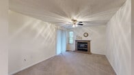 Located at 1100 Belmont Blvd in Monroeville, PA, this well-appointed 2-bedroom, 2-bathroom residence offers a thoughtfully designed single-floor layout. The living room serves as the centerpiece of the home, featuring a tile-surround fireplace, plush wall-to-wall carpeting, a ceiling fan with light fixture, and a textured ceiling. Vertical blinds lead to a window that fills the space with natural light, creating a warm and inviting atmosphere. The galley-style kitchen is outfitted with white cabinetry, granite-look countertops, hardwood-style flooring, and black stainless appliances including a refrigerator, range, and dishwasher — offering both functionality and a clean aesthetic. Both bedrooms are carpeted and include ceiling fans, with the primary bedroom offering a generous footprint, a closet, and direct access to its en-suite bathroom. The primary bath features warm wood-toned cabinetry, a white countertop vanity, and a tub-shower combination with tile flooring. The second bathroom mirrors this design with a tub-shower, vanity, and tile floors. Each room reflects a consistent, neutral color palette throughout, providing a versatile canvas for personalization.