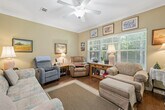 Located at 700 Jubilee Cir in Pell City, Alabama, this two-story townhome offers a well-designed layout spread across two floors. The classic brick exterior, complemented by a welcoming entry and attached garage, gives the home strong curb appeal within a well-maintained community setting.

The main floor hosts the primary living areas, including a comfortable living room with hardwood flooring, crown molding, a ceiling fan, and a large window that invites natural light. Adjacent to the living room, the dining area features elegant crown molding and a chandelier overhead. The galley-style kitchen is efficiently laid out with warm wood cabinetry, granite-look countertops, hardwood floors, and black appliances including a range and refrigerator.

The bathrooms are well-appointed, with one featuring rich wood cabinetry, a wide vanity with an extended mirror, and bright overhead lighting. Tiled shower enclosures with built-in shelving are present throughout.

The bedrooms offer carpeted floors and ceiling fans. The generously sized primary bedroom provides ample space, while the second bedroom includes a closet and direct access to a private bathroom. With four bathrooms across the home, convenience and functionality are priorities throughout this thoughtfully arranged two-story residence.