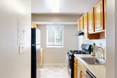 Located at 25 School Dr in Gaithersburg, MD, this single-floor residence offers three bedrooms, one bathroom, and a thoughtfully arranged layout that maximizes functionality. The entryway features tile flooring that transitions into soft carpet throughout the main living areas and bedrooms, creating a warm and cohesive feel. The living room is a comfortable gathering space accented by natural light from windows and offers room for a variety of furniture arrangements. The kitchen is equipped with light wood cabinetry, ample counter space, a gas range, and a window with blinds that allows in natural light and views of surrounding greenery. The primary bedroom is generously sized, featuring a walk-in closet, plush carpeting, and a window overlooking outdoor foliage, lending a tranquil atmosphere. The two additional bedrooms are carpeted and well-proportioned, each offering closet access and neutral wall tones suitable for a range of uses. The full bathroom includes a wood-toned vanity with an integrated sink, a mirror with overhead lighting, and tile flooring. Two closets provide added storage convenience throughout the unit. Overall, the space maintains a clean, neutral palette that offers a versatile and comfortable living environment.