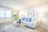 Located at 254 W Bay Ave in Norfolk, Virginia, this single-story residence offers a well-organized layout that balances functionality with comfortable living. Wood-look flooring flows consistently throughout the home, creating a cohesive aesthetic across all rooms.

The living area is generously proportioned, featuring neutral walls that complement the light-toned flooring. The space accommodates a full seating arrangement and media setup with ease, providing a relaxed and welcoming atmosphere.

The kitchen is equipped with warm honey-toned cabinetry, stone-patterned countertops, a double basin sink, and black gas appliances. An adjacent pantry with open shelving provides practical storage.

The home includes two bedrooms. The primary bedroom is spacious, featuring a window that brings in natural light, neutral walls, and ample room for full bedroom furnishings. A second bedroom offers a closet with sliding doors and a window overlooking the exterior, making it well-suited as a guest room or home office.

The bathroom features white subway tile wainscoting, a white vanity with a mirror, wood-look tile flooring, and a shower-tub combination enclosed by a curtain, maintaining a clean and classic aesthetic throughout.