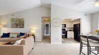 Located at 2555 Summer Dr. in Columbus, OH, this thoughtfully designed one-bedroom, one-bathroom residence offers a functional and inviting layout across a single floor. The open-concept living and dining area is highlighted by soaring vaulted ceilings that lend an airy, expansive feel, along with a classic white brick fireplace that serves as a focal point. Plush carpeting flows throughout the main living spaces, while wood-style flooring accents the kitchen and bathroom. Large windows throughout the home invite abundant natural light and offer pleasant outdoor views of surrounding greenery.

The kitchen features white cabinetry with ample storage, dark countertops, and black appliances, including a range and built-in microwave. The adjacent dining area benefits from generous window coverage and a ceiling fan, creating a bright and comfortable space for meals. The spacious bedroom includes multiple windows, generous closet space, and soft carpeting. The bathroom is equipped with a full tub-shower combination and a window for natural ventilation. Additional highlights include a private balcony, in-unit laundry, a utility room, and three closets providing excellent storage throughout the home.