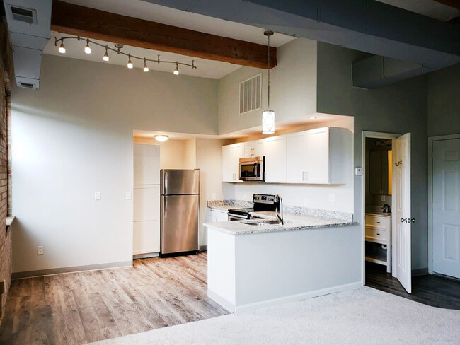 Hardwood-Style Flooring and Unique Lighting Fixtures - Grand Ledge Apartments