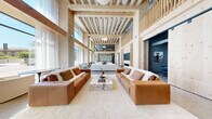 Located at 394 West Ave in Norwalk, CT, this generously scaled single-floor space makes an immediate impression with its soaring double-height ceilings and exposed mass timber framing that define its architectural identity. Floor-to-ceiling windows flood the expansive living area with abundant natural light while offering views of the surrounding streetscape, creating a bright and airy atmosphere anchored by polished concrete floors throughout.

The main living area is a standout feature, designed to accommodate multiple seating arrangements with a sense of openness and flow. A terrazzo-clad island with bar seating serves as a social hub, complemented by open wood shelving and a refined kitchenette finished in dramatic matte black cabinetry, a textured tile backsplash, and integrated appliances.

A dedicated library lounge offers a striking contrast, with dark ceiling treatments, floor-to-wall built-in shelving, and intimate ambient lighting that create a moody, sophisticated retreat. A children's playroom is thoughtfully designed with natural wood built-ins, a pegboard feature wall, and a whimsical teepee, providing a bright and engaging space for younger occupants.

The bedroom provides a more private sanctuary within the layout. Throughout the space, the interplay of warm natural wood, polished concrete, and carefully curated finishes establishes a cohesive modern aesthetic that is both functional and visually compelling.