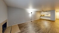 Located at 775 Cascade St in Oregon City, Oregon, this single-floor, 2-bedroom, 2-bathroom home offers a practical and comfortable layout. The combined dining and living area is a generous open space featuring wood-style flooring, neutral gray walls, and a tiled fireplace framed by a large window that brings in natural light and outdoor views. A ceiling fan adds to the room's functionality.

The kitchen is well-appointed with white cabinetry, granite-style countertops, track lighting, and white appliances including a range and refrigerator. It connects conveniently to the living and dining area via a breakfast bar, with an adjacent pantry for additional storage.

Both bedrooms are carpeted and offer a calm, neutral palette. Each bedroom includes a mirrored sliding-door closet, and windows allow for natural light. The primary bedroom includes its own dedicated closet space. The two bathrooms feature wood-style flooring, white vanities with stone-look countertops, and tub-shower combinations with chrome fixtures.

Additional highlights include a dedicated laundry area, a hallway with access to all rooms, a welcoming entrance, and three total closets throughout. The home provides a well-organized, efficient floor plan suited for everyday living.