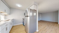 Located at 49 Arborwood Crescent in Rochester, NY, this one-bedroom, one-bathroom unit offers a thoughtfully arranged single-floor layout with clean, modern finishes throughout. The living room is an inviting, open space featuring light wood laminate flooring, soft gray walls, a textured ceiling, and a window that allows natural light to fill the room. A hallway connects the main living areas and leads to the bedroom, bathroom, and utility room with ease. The kitchen is efficiently designed with crisp white cabinetry, a stainless steel refrigerator, a range, and a sink with a modern faucet. A window adjacent to the kitchen brings in additional natural light, brightening the space. The bedroom offers a comfortable retreat, featuring plush gray carpeting, soft neutral walls, and a window with blinds that provides natural light and outside views. The bathroom is clean and functional, equipped with a full tub-shower combination finished in white surround panels. Throughout the unit, consistent light-toned flooring, neutral color palettes, and well-maintained surfaces create a cohesive and welcoming atmosphere, making this an ideal, easy-to-maintain living space.