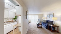 This one-bedroom, one-bathroom unit at 111 Grafton Ave in Dayton, Ohio offers a well-organized, single-floor layout that makes efficient use of its cozy footprint. The entrance leads into a hallway that connects the key living spaces throughout the unit. The living room is a bright, welcoming area featuring neutral carpet, soft wall tones, and a large sliding glass door fitted with vertical blinds that allow ample natural light to filter in. The kitchen is efficiently designed with abundant white cabinetry, granite-style countertops, a double-basin sink, and a gas range, providing all the essential amenities for everyday cooking. A pass-through counter connects the kitchen to the adjacent dining area, enhancing the sense of openness between the two spaces. The bedroom is a calm, comfortable retreat featuring carpet flooring, a window with natural light, and a built-in open closet with a hanging rod for convenient storage. The bathroom is clean and well-appointed, featuring a single vanity with under-sink storage, a mirrored medicine cabinet, and a shower-tub combination. Throughout the unit, a consistent light color palette and neutral finishes create a cohesive, move-in-ready atmosphere.
