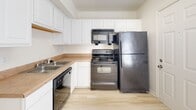 Located at 3511 Briel St in Richmond, Virginia, this two-floor home offers a clean, neutral aesthetic with practical finishes throughout. The interior is designed with simplicity and functionality in mind, featuring light-toned hardwood-style flooring that flows through the main living areas and kitchen, contributing to a bright and airy feel.

The kitchen is well-equipped with white raised-panel cabinetry offering generous storage, a stainless steel sink, and black appliances including a refrigerator, range, over-the-range microwave, and dishwasher. The layout is efficient, making good use of the available space.

The bedrooms feature neutral carpet flooring and are finished with crisp white walls, providing a calm and comfortable atmosphere. Windows fitted with horizontal blinds allow for natural light while maintaining privacy. Each room is generously proportioned with clean lines and standard ceiling heights.

The bathroom includes a full tub-shower combination with a curved curtain rod, toilet, and wood-style flooring, all presented in a light, clean palette. The overall design of the home is understated and move-in ready, with a consistent use of white and neutral tones that lend versatility to each space. The two-floor layout offers separation between living and sleeping areas, adding to the home's practical appeal.